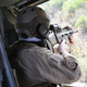 A U.S. Customs and Border Protection (CBP) agent aims his weapon from a Black Hawk helicopter while pursuing a truck with suspected undocumented immigrants on February 21, 2018 in McAllen, Texas.